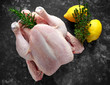 Whole raw Free range chicken in rustic background with rosemary leaf, thyme, lemon. ready to cook