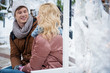 © Yakobchuk Olena - Portrait of happy young man admiring beauty of his loving girlfriend. They are sitting on bench in winter park and smiling