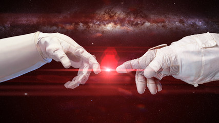 Wall Mural - two near touching hands in space suits, with the milky way and a bright red star