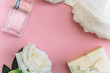 top view of rose,perfume bottle,gift box and bra on a pink background copy space