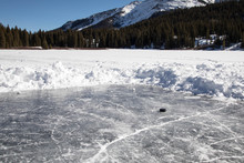Hockey Puck On A Small Pond Hockey Rink In The Mountains