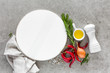 © Sea Wave - Culinary background with empty plate and space for a text, flat lay composition of oil, chili peppers, rosemary, onion and spices on a table stone surface, top view