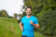 © baranq - Happy man running in park during summer