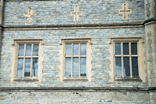 Old Traditional English Architecture, Three Windows And Crosses Above