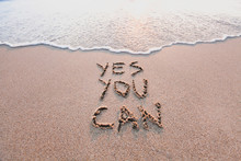 Yes You Can, Motivational Inspirational Message Concept Written On The Sand Of Beach