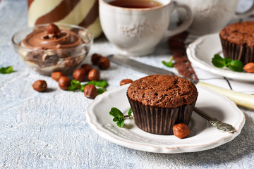 Wall Mural - Chocolate muffins with nuts and peanut butter on a concrete background