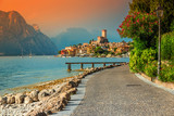Fototapeta  - Fantastic Malcesine tourist resort and colorful sunset, Garda lake, Italy