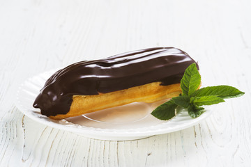 Eclairs on plate on a table