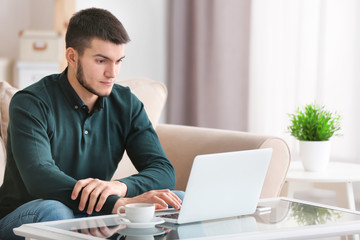 Sticker - Young man using modern laptop at home