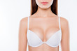 Cropped close up photo of sexy woman's breast wearing white classic elegant brassiere she has clean clear sensual fresh  pure skin, skinny slim slender body isolated on background
