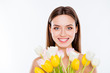 Wellness vitality womanhood no plastic surgery concept. Close up portrait of attractive gorgeous woman with pure ideal flawless smooth sensitive skin holding yellow white tulips isolated on background