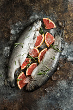 Overhead View Of Trout Fish With Grapefruit On Wooden Background