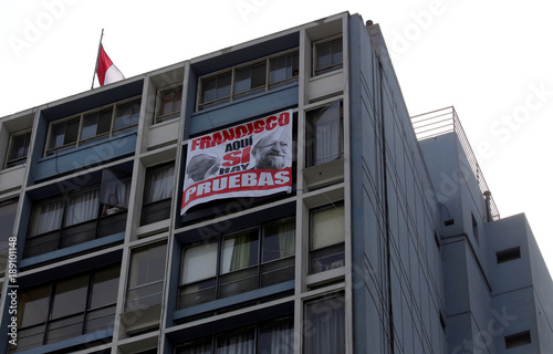 A Banner Hanging From An Apartment Window Reads Francis We Have