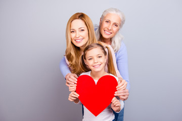 Sticker - Motherhood relationship maternity loveliness tenderness cute blonde-haired parenthood generation concept. Beautiful cheerful excited granny mom kid holding one big heart isolated on gray background