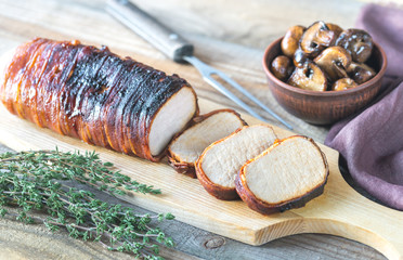 Canvas Print - Pork loin wrapped in bacon with roasted mushrooms