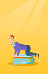 Canvas Print - Young caucasian white man sitting on a suitcase and trying to close it. Frustrated man having problems with packing a lot of clothes into a suitcase. Vector cartoon illustration. Vertical layout.