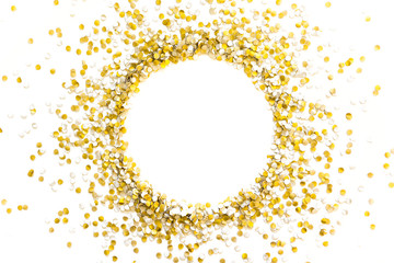 Golden shiny confetti on a white background. Round frame made of confetti. Festive confetti.