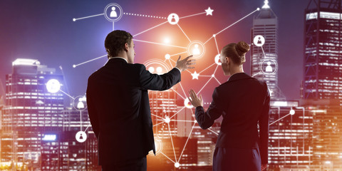 concept of social connection and networking against night city view and partners working in cooperat