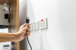 © Ton Forio - Hand are plugged in or unplugged electricity. Separated from a white background.