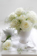 Vase of white Roses with tea