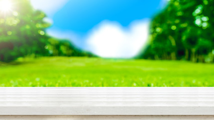 Aufkleber - Empty white wood table top with blur green grass field natural park in sunny day.Mock up for display of product,Banner or header for advertise on social media,Spring and Summer background