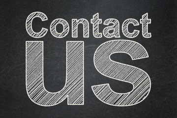 marketing concept: text contact us on black chalkboard background