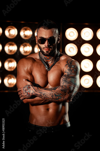 Valokuva Sexy closeup portrait of brutal handsome male model with a black beard and in sunglasses