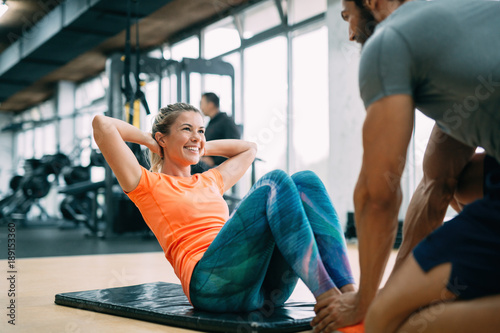Fotografia Personal trainer assisting woman lose weight