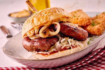 Wall Mural - Grilled spicy bratwurst burger on a sesame bun