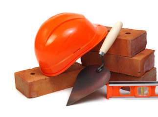 Brick, red hard hat and tools