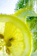 Wall Mural - Lemon drop in fizzy sparkling water, juice refreshment