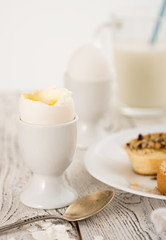 Breakfast with boiled egg, milk and fried bread.