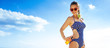 happy active woman in beachwear on beach applying suntan lotion