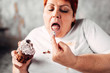© Nomad_Soul - Overweight woman eats sweet cake, obesity