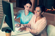 © Viacheslav Yakobchuk - Best help. Charming young woman sitting next to her female colleague and suggesting her some ideas about possible improvements while the woman working on her project