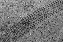 Tyre Track On Sand In Black And White.