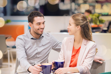 Canvas Print - happy couple with shopping bags drinking coffee