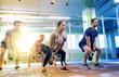 © Syda Productions - group of people with kettlebells exercising in gym