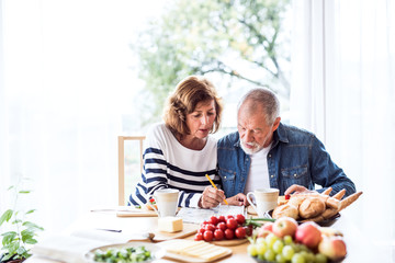 Sticker - Senior couple eating breakfast at home.