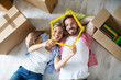 © didesign - Attractive young couple relax between boxes on floor at new apartment