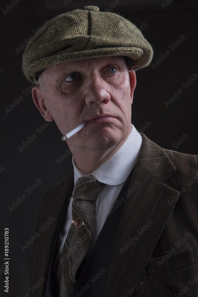 Portrait of a mature gangster smoking a cigarette Stock Photo