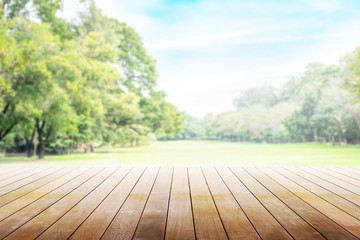 Empty wooden table with party in garden background blurred.