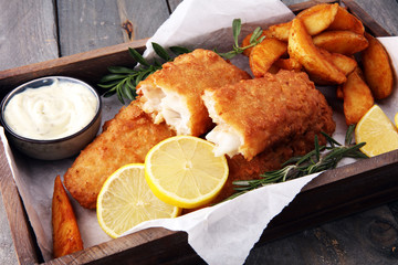 traditional British fish and chips with potato and lemon