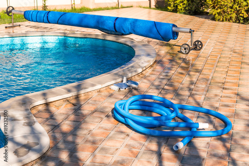 Fotografie, Obraz Manual equipment for cleaning pool, brush, hose, swimming pool cover, Yesulskaya, Krasnodar, Russia