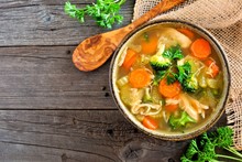 Homemade Chicken Vegetable Soup, Above View With Copy Space On A Rustic Wooden Background