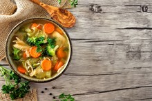 Homemade Chicken Vegetable Soup, Above View Side Border With Copy Space On A Rustic Wooden Background