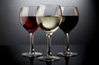 Red, rose and white wine glasses in a black background
