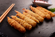 Fried shrimps on sticks in crispy coating