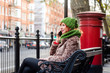 Young London lifestyle woman Talking on Mobile with red postbox on background