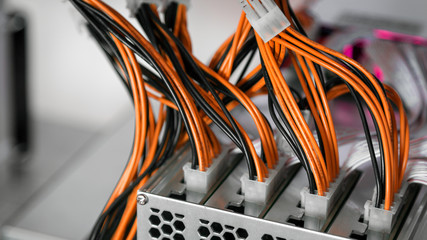 Fototapete - Close-up of cryptocurrency mining: cable, orange lights